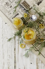 orange marmalade in small glass jars with rosemary, selective focus
