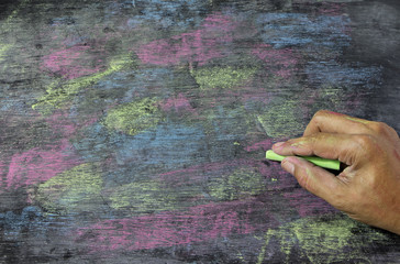 colorful chalks on blackboard background.