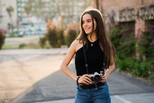 Pretty woman using a DSLR camera