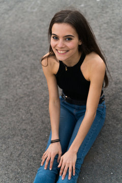 Cheerful woman sitting on the ground