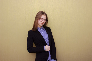 Smart business woman with glasses portrait isolated on yellow