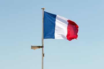 Beautiful french flag under blue sky and loud speaker