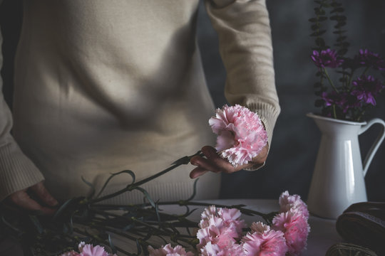 Graceful hands of the woman florist making bouquet of flowers