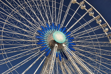 Blau-weißes Riesenrad vor blauem Himmel im Hafen von Marseille