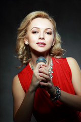 woman in red with microphone