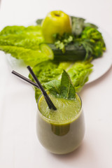Healthy green smoothie and ingredients - superfoods, detox, diet, health, vegetarian food concept.