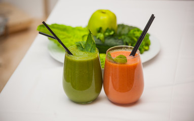 Healthy green and red smoothies and ingredients - superfoods, detox, diet, health, vegetarian food concept
