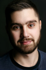 Obraz premium Portrait of handsome man with dark beard and shiny smile