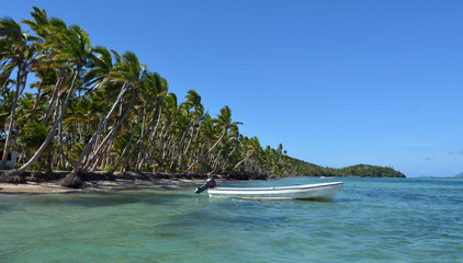 White fishing boat on a tropical island in Fiji