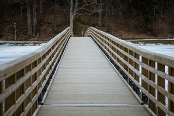 A beautiful wooden bridge over the frozen river