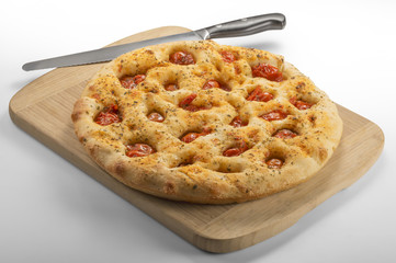 Apulian flat bread with tomatoes and knife