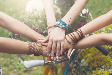 United hands of girlfriends closeup, young girls in boho bracelets © Prostock-studio
