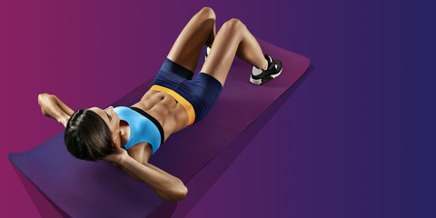Sports background. athletic woman working ab intervals in fitness.