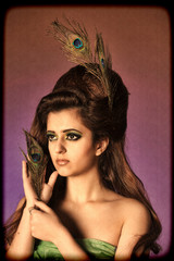 Girl with a peacock feather and creative make-up