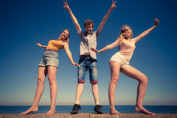Obraz premium Group friends boy two girls having fun outdoor