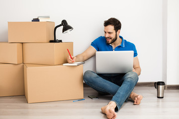 man lying on the floor with packing boxes