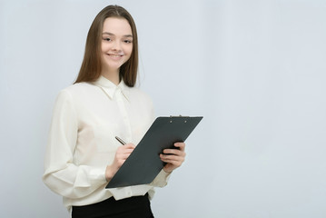 Young pretty business woman with tablet paper isolated on white background