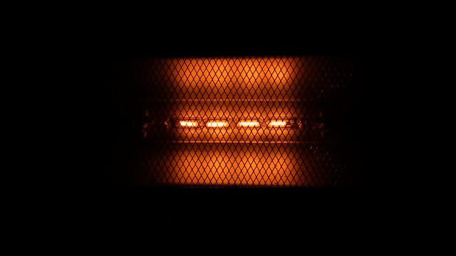 Tungsten light bulb lamp blinking over black background, macro view, loop ready