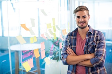 Fototapeta premium Man standing next to the sticky notes on wall in office