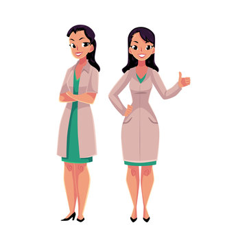 Two female, woman doctors in white medical coats, one with arms folded, another showing thumb up, cartoon vector illustration isolated on white background. Full length portrait of two female doctors