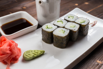 Japanese cuisine. Sushi roll with avocado on white background