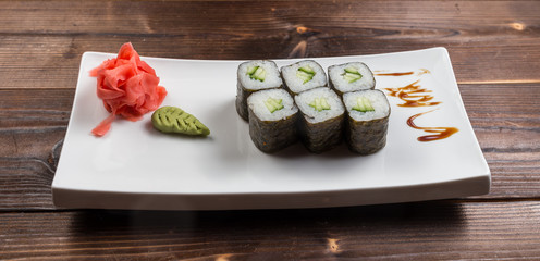 Japanese cuisine. Sushi roll with avocado on white background