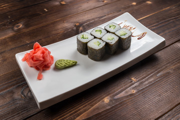 Japanese cuisine. Sushi roll with avocado on white background