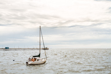 Sailboat sailing on the Rio de la Plata, Argentina, with pier on background