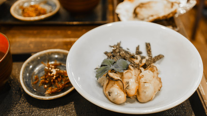 Oysters on Japanese steamed rice in Miyajima Island, Hiroshima , Japan