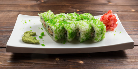 healthy kale and avocado sushi roll with chopsticks