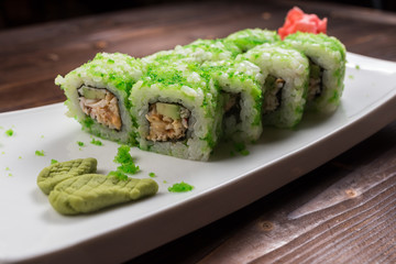 healthy kale and avocado sushi roll with chopsticks