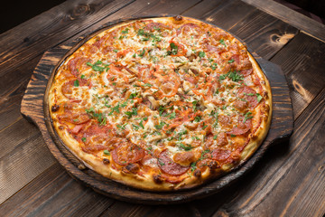 Pepperoni pizza on a board