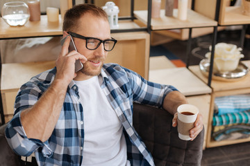 Handsome bearded man having coffee