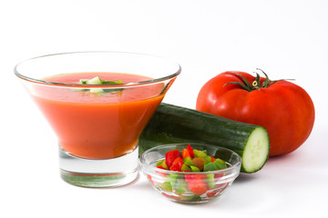 Traditional Spanish cold gazpacho and ingredients soup isolated on white background
