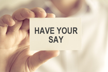 Businessman holding HAVE YOUR SAY message card