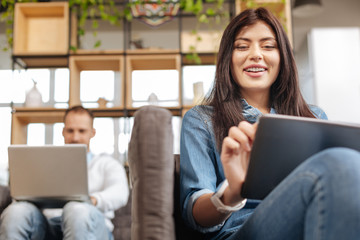 Joyful happy woman using a tablet