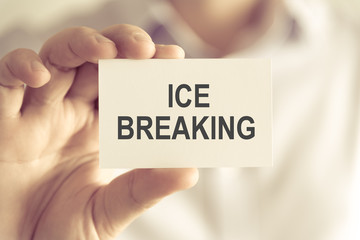 Businessman holding ICE BREAKING message card