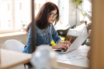 Confident self employed woman working in her office