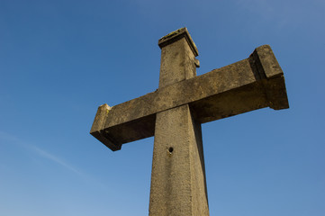 stone cross against a blue sky 