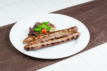 Tasty Grilled Sausages In White Plate