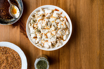 Turkish Manti Manlama / Ravioli with yogurt and fried butter sauce. copy space.