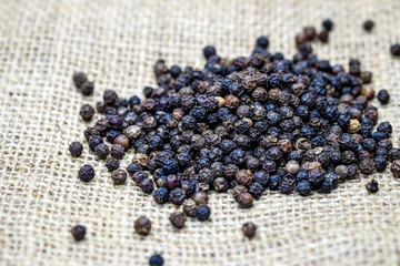 Black pepper seeds on sackcloth brown.