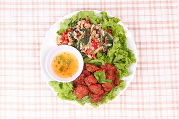 Fried spicy basil with minced pork and curried fish cake.