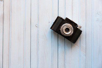 top view of retro style camera on blue wooden table