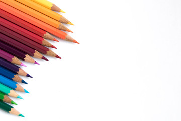 Colored pencils on a white background. Pencils rainbow. Place for your text on he right.