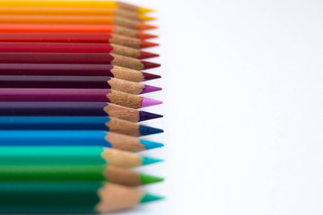 Colored pencils on a white background. Pencils rainbow. Place for your text on he right.