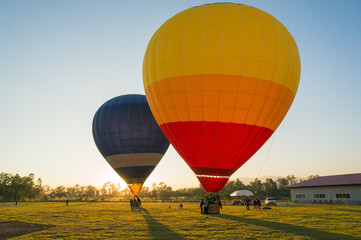 Two big balloon ready to take off at green field