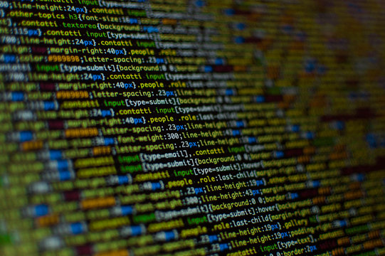 Software development. Software source code. Programming code. Writing programming code on laptop.