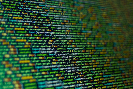 Software development. Software source code. Programming code. Writing programming code on laptop.