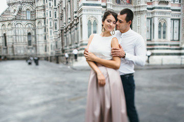 Fototapeta premium Loving young couple hugging each other in city center of Florence